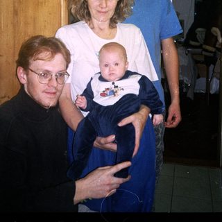 Family portrait with grandparents, parents, and baby.