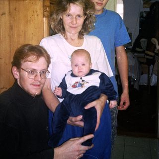 Family portrait with grandparents, parents, and baby.