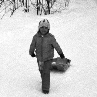 Child skiing on snow-covered slope.