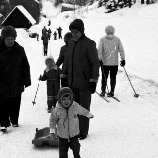 People skiing and sledding in snowy outdoor setting.