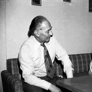 Older man and young child sharing a meal indoors.