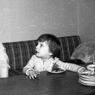 Older man and young child sharing a quiet moment indoors.