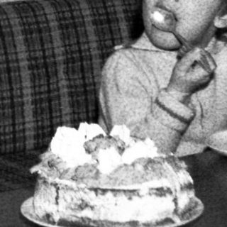 Man and child celebrating birthday with cake.