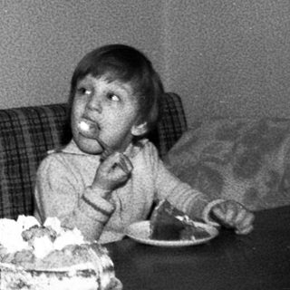 Man and child celebrating birthday with cake.