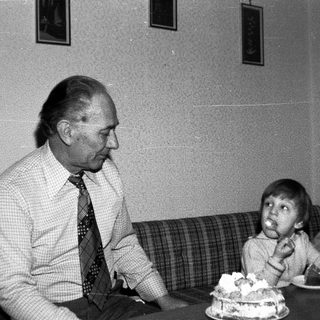 Man and child celebrating birthday with cake.