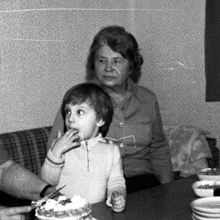 Family sharing cake indoors during a gathering.