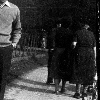 Man standing outdoors in a garden area.