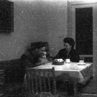 Two people seated indoors, sharing a meal.