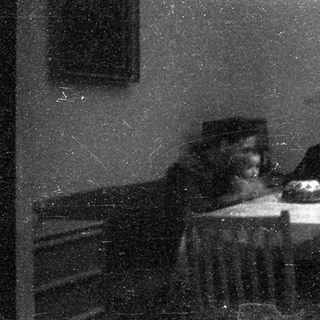 Two people seated indoors, sharing a meal.