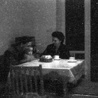 Two people seated indoors, sharing a meal.