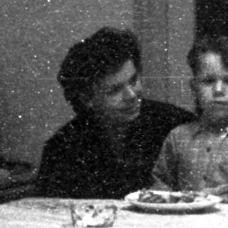 Family sharing meal indoors during evening.