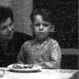 Family sharing meal indoors during evening.