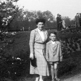 A woman and young boy standing outdoors together.