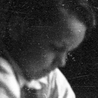 A person sitting at a desk writing.
