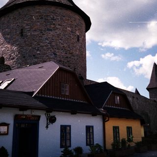 Medieval tower and traditional European village houses.