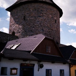 Medieval tower and traditional European village houses.