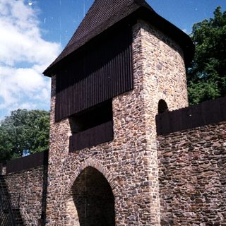 Medieval stone watch tower with arched entrance.