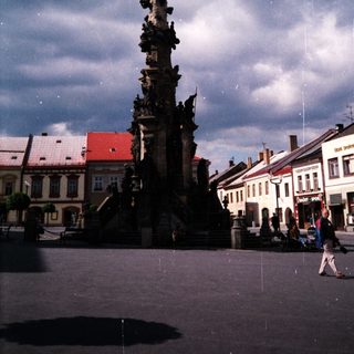 Baroque-style column monument in town square.