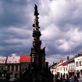 Baroque-style column monument in town square.