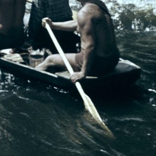 Group rowing boat on turbulent river.