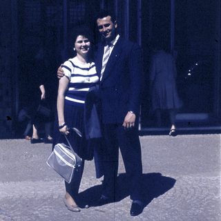 Couple posing together outdoors in vintage clothing.