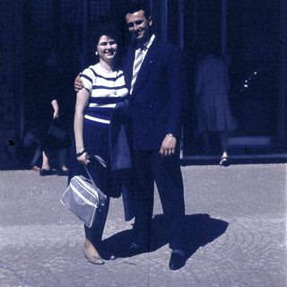 Couple posing together outdoors in vintage clothing.