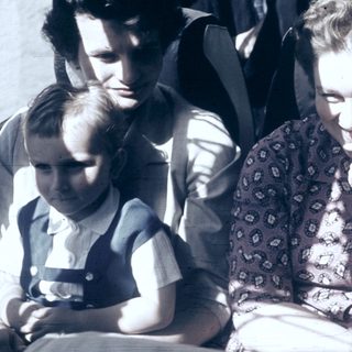 Family group in vintage photograph, mid-20th century.
