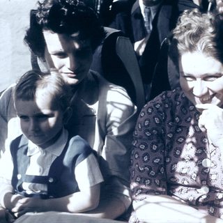 Family group in vintage photograph, mid-20th century.