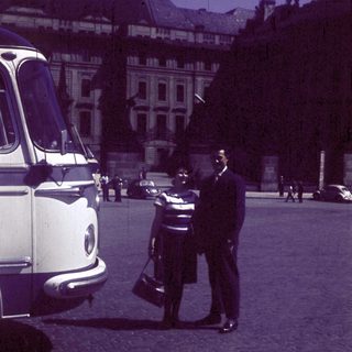 Classic car parked near man in uniform.