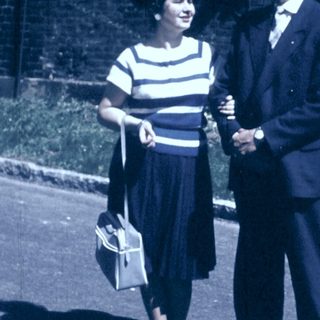 Couple posing outdoors in vintage 1950s-60s attire.