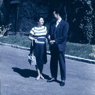 Couple posing outdoors in vintage 1950s-60s attire.