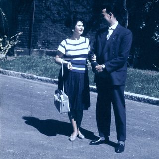 Couple posing outdoors in vintage 1950s-60s attire.