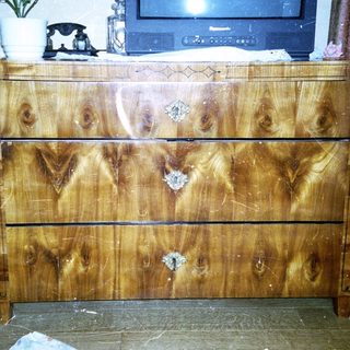 Vintage wooden dresser with four drawers.