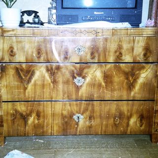 Vintage wooden dresser with four drawers.