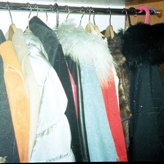 Clothes rack with winter coats and fur jackets.