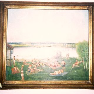 Scenic outdoor gathering by lake with people relaxing.