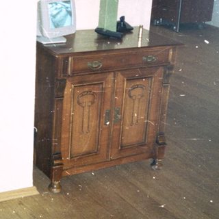 Flooded room with water-covered wooden floor.