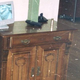 Flooded room with water-covered wooden floor.
