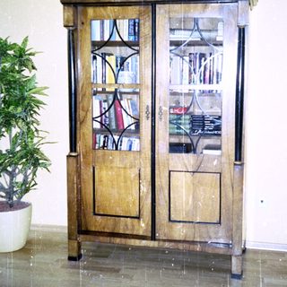 Antique wooden cabinet with stained glass doors.