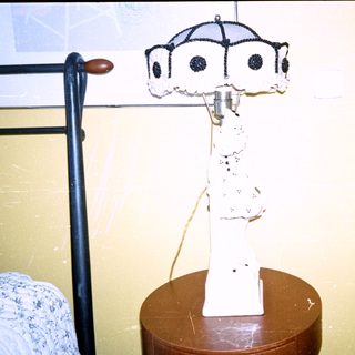 Vintage-style lamp on wooden stool.