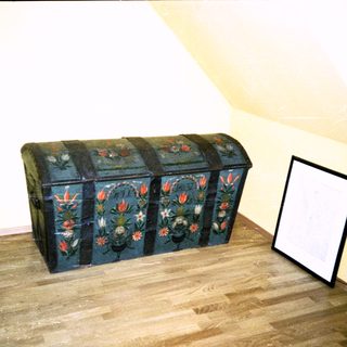 Vintage wooden trunk with floral painted designs.