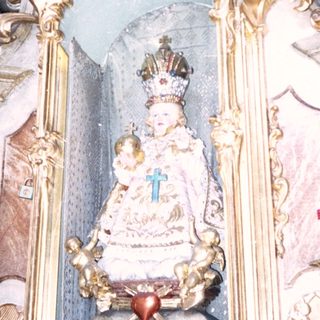 Baroque altar featuring ornate statue of Virgin Mary.