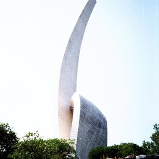 Modern abstract sculpture resembling curved wings.