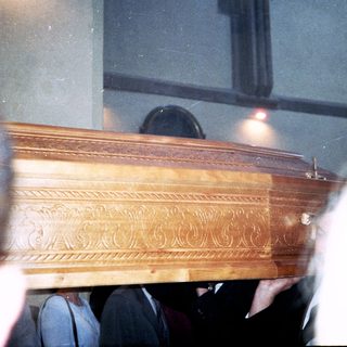 Elaborate wooden coffin during a funeral service.