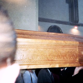 Elaborate wooden coffin during a funeral service.