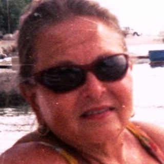 Woman relaxing on beach lounge by sea.