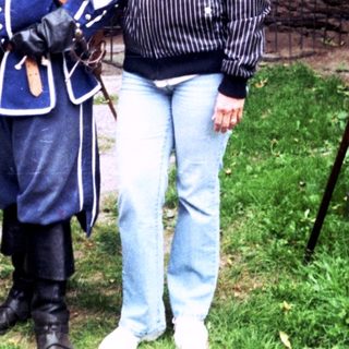 Historic reenactment participants posing with vintage military attire.
