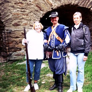 Historic reenactment participants posing with vintage military attire.