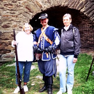 Historic reenactment participants posing with vintage military attire.