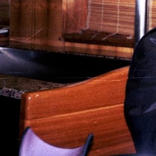 Man sitting indoors in a rustic restaurant setting.